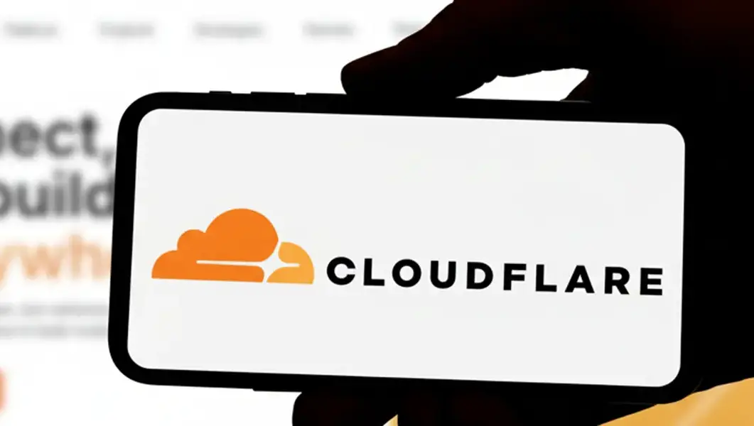 Cloudflare logo on a smartphone in front of the website, used to illustrate our latest news update on the recent Cloudflare outage.