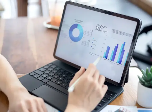 Business professional reviewing website performance and sales analytics on a tablet