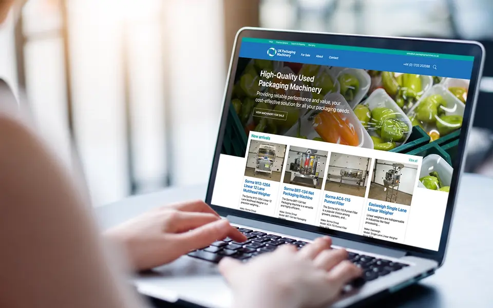 Custom e-commerce website displayed on a laptop, showcasing an online machinery catalogue and product listings.