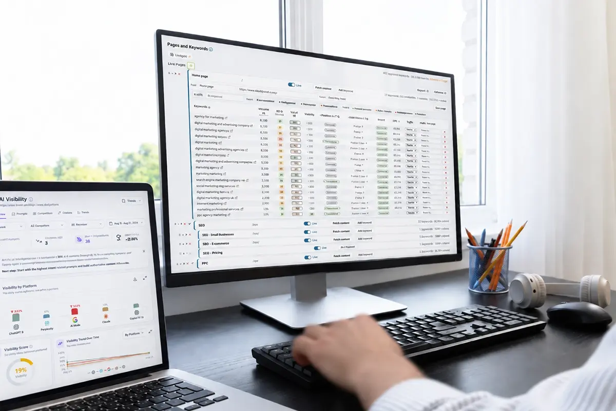 SEO specialist reviewing keyword rankings and AI visibility data across desktop and laptop screens.