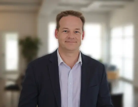 Gary Cottam, SEO and PPC consultant, smiling in an office setting during a client meeting.
