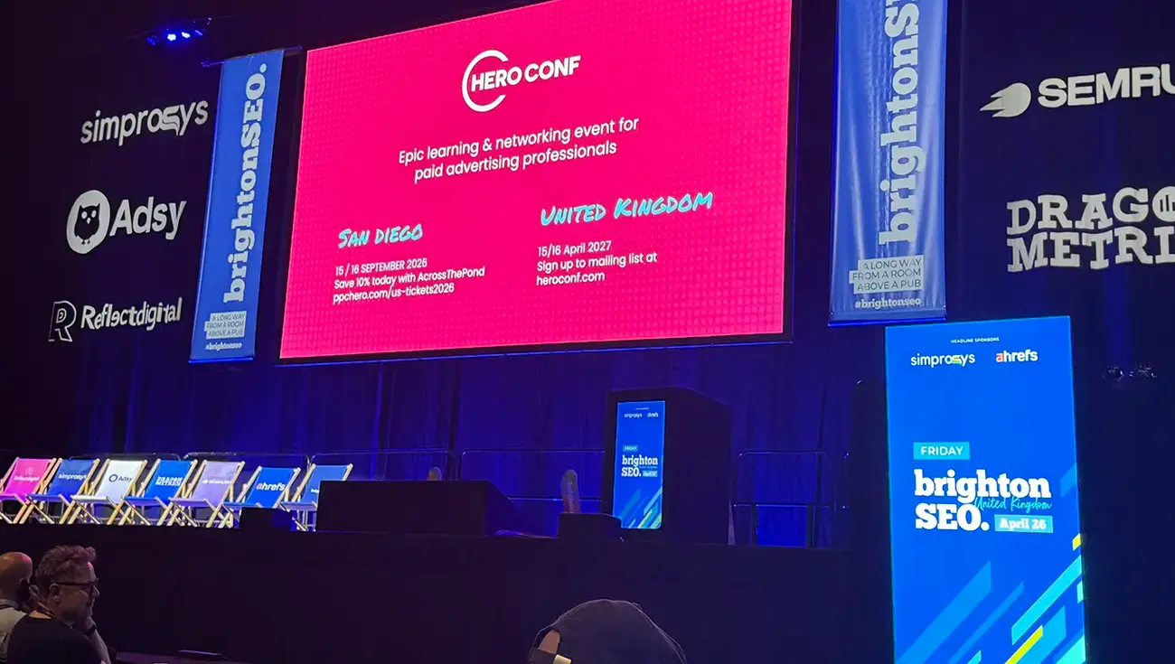 Hero Conf paid advertising stage at brightonSEO 2026, with sponsor banners and upcoming event dates for San Diego and the UK.