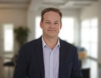 Gary Cottam, SEO and PPC consultant, smiling in an office setting during a client meeting.