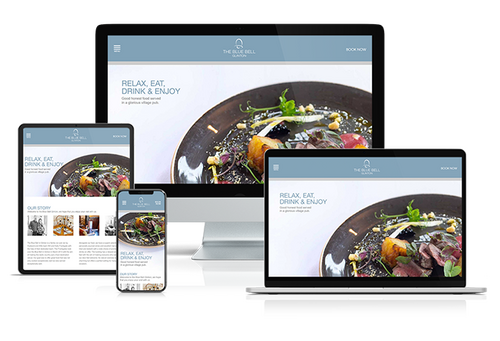Responsive website design for The Blue Bell Glinton, a fine dining restaurant, displayed across desktop, laptop, tablet, and smartphone devices. The layout features elegant visuals, clean typography, and booking functionality optimised for seamless browsi