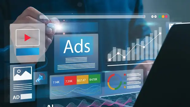 Laptop displaying Google Ads analytics dashboard with charts and graphs showing campaign performance metrics.
