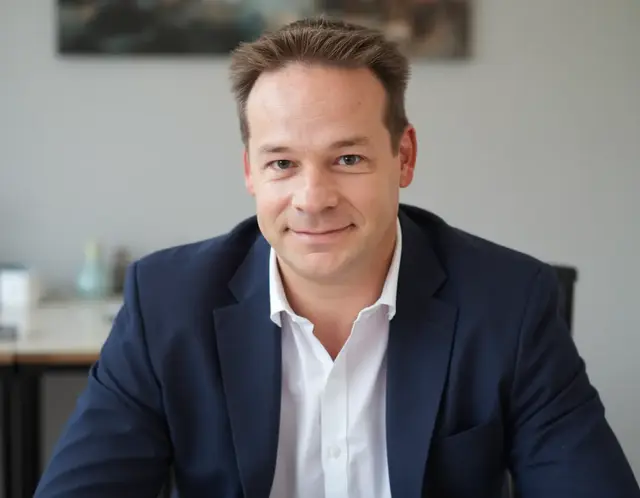 Head-and-shoulders photo of Gary Cottam in the office with a relaxed smile