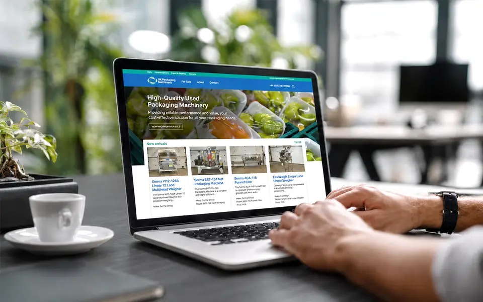 E-commerce website displayed on a laptop showing used packaging machinery products for sale.