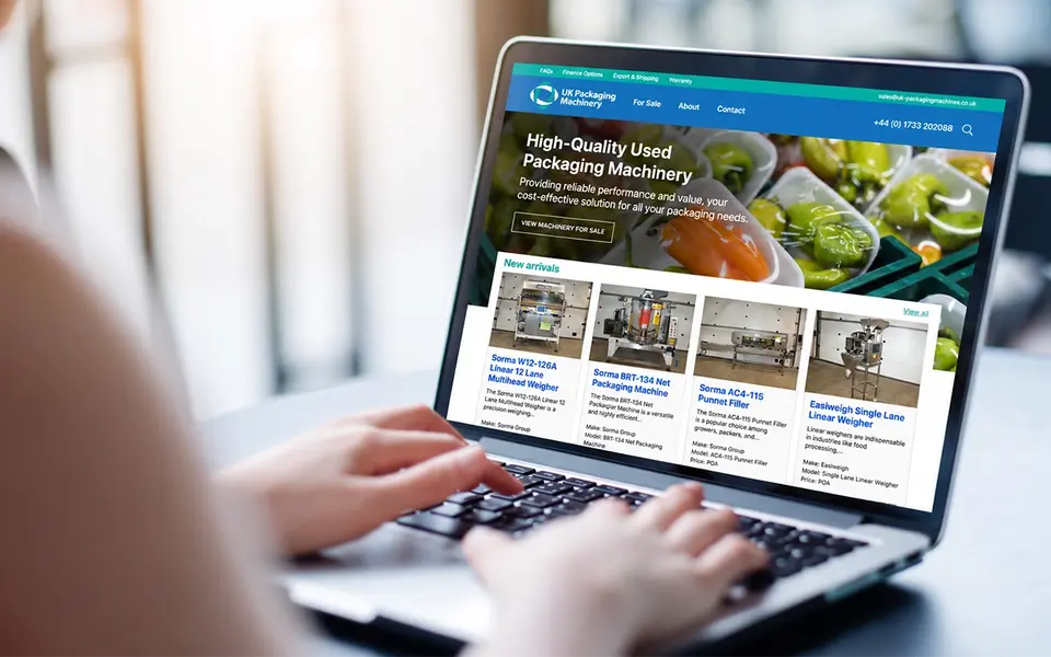 Custom e-commerce website displayed on a laptop, showcasing an online machinery catalogue and product listings.